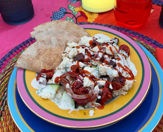 Polychrome's chicken gyros rice bowl with halal white sauce, roasted cherry tomatoes, kalamata olives, cucumber, and feta