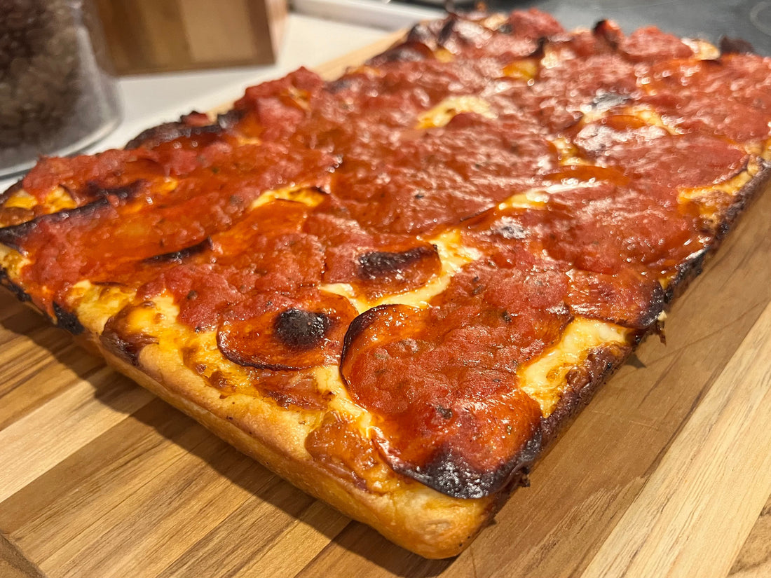 Detroit-style pepperoni pizza with crisp, caramelized cheese edges